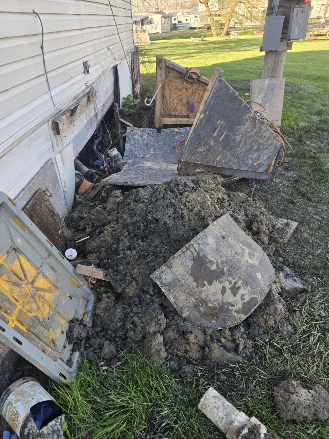 Excavated ground and removed concrete beside a building